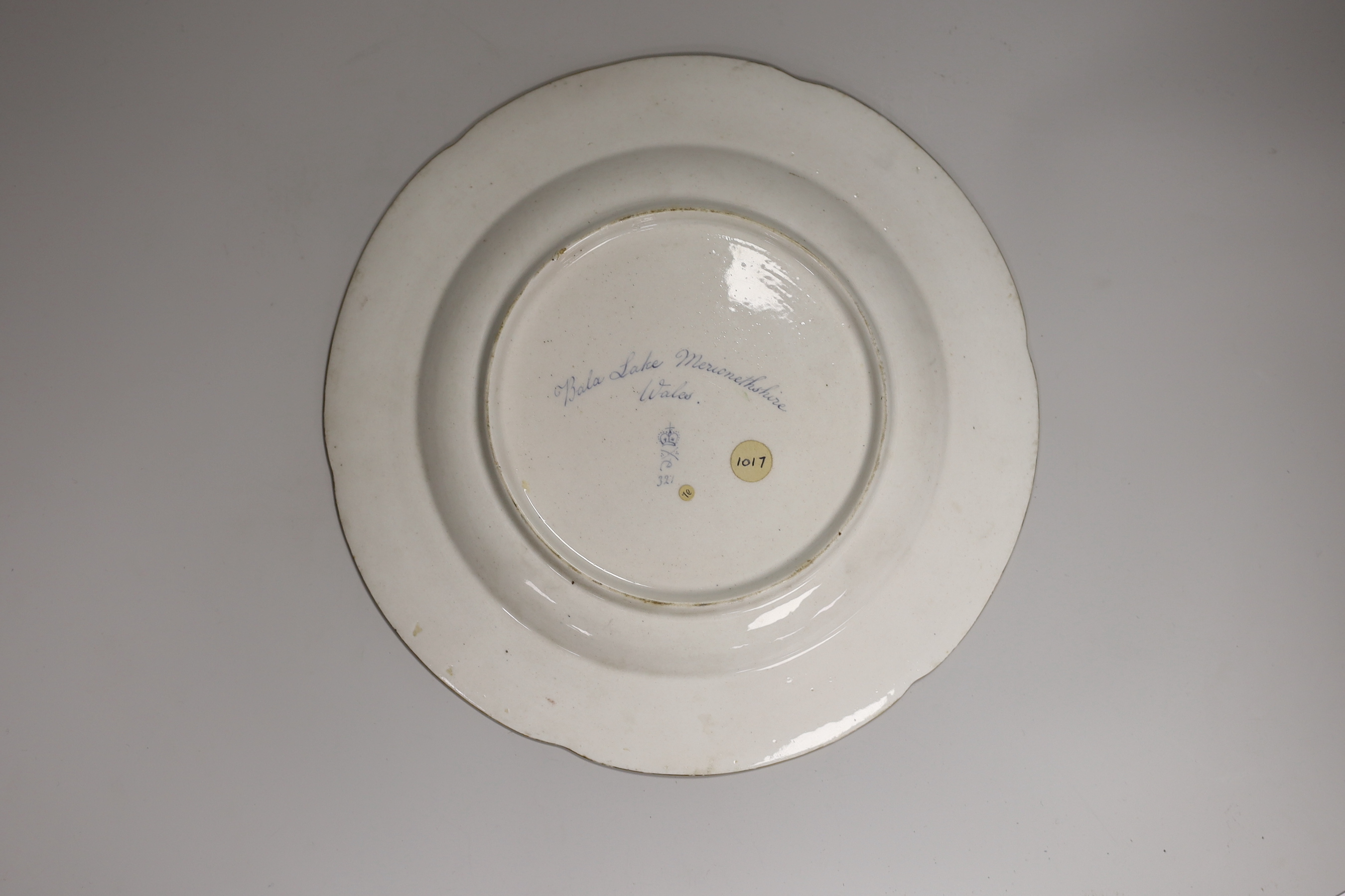 An 18th century Derby plate by George Robertson painted with Bela Lake Merionethshire, Titled, blue mark, 26cm diameter